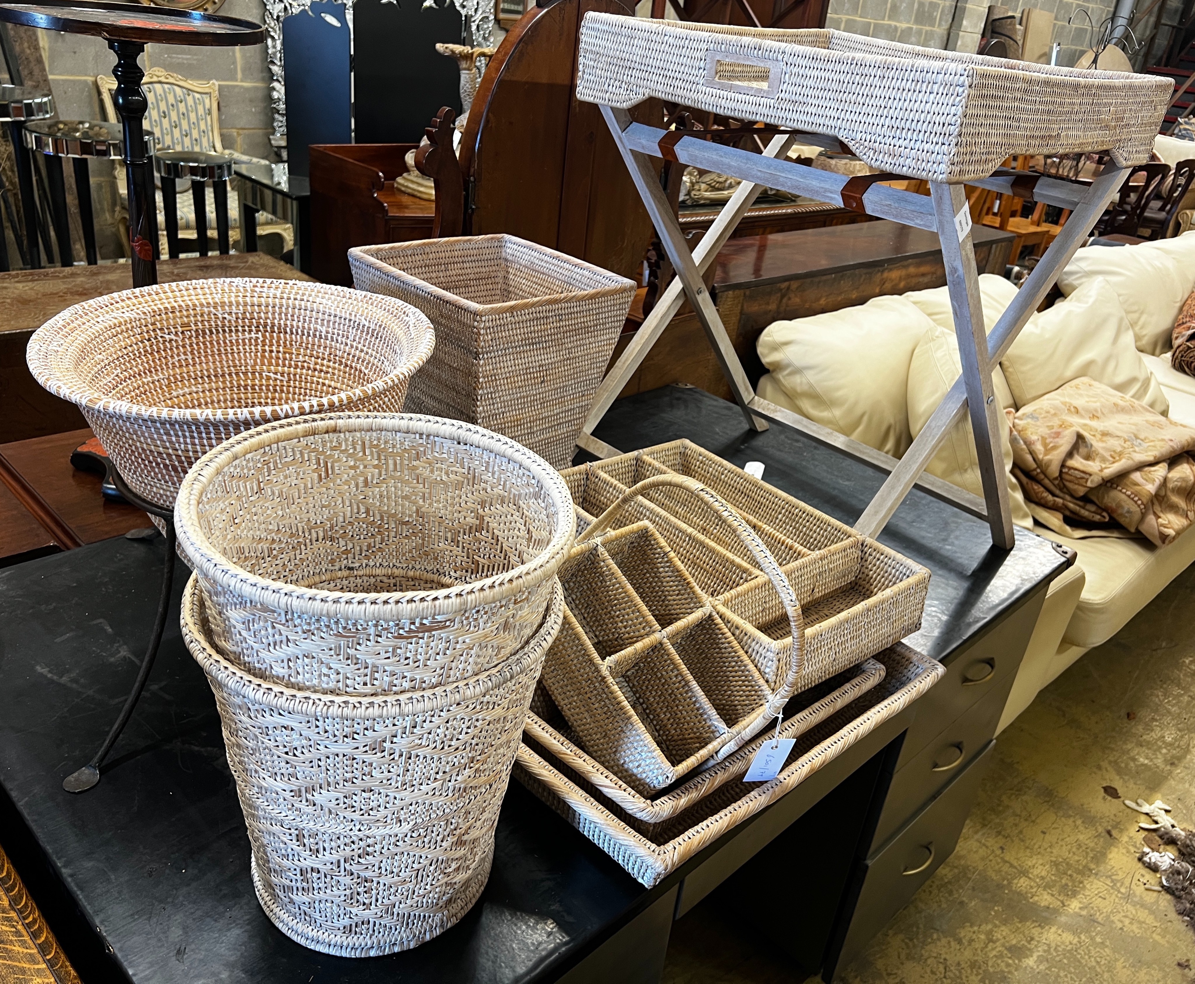 A wicker tray on folding stand together with nine other pieces of wickerwork